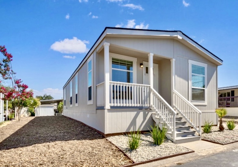 Exterior of a BMH home with a covered porch and landscaped entry